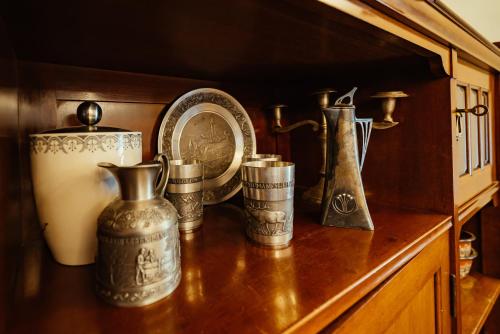 a shelf with various metals on top of a table at Zoev House in Karlovo