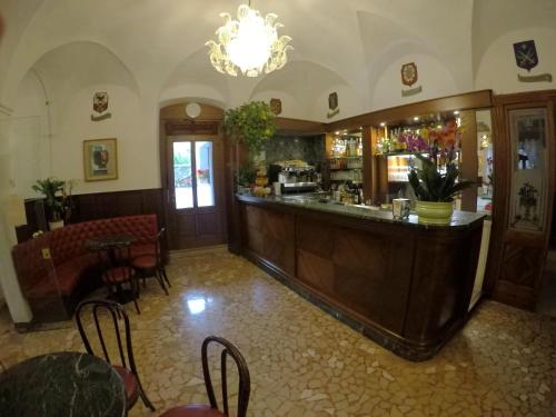 a restaurant with a bar with chairs and a table at Hotel Ristorante Combolo in Teglio