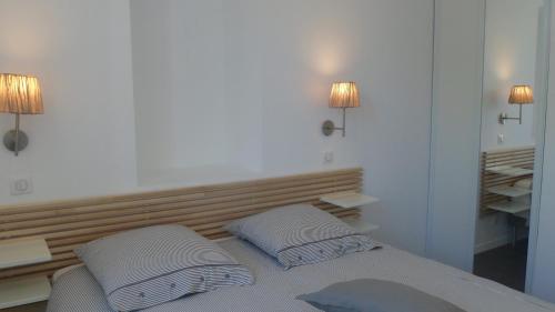 a bedroom with a bed with two pillows on it at Les Halles 1 in La Rochelle