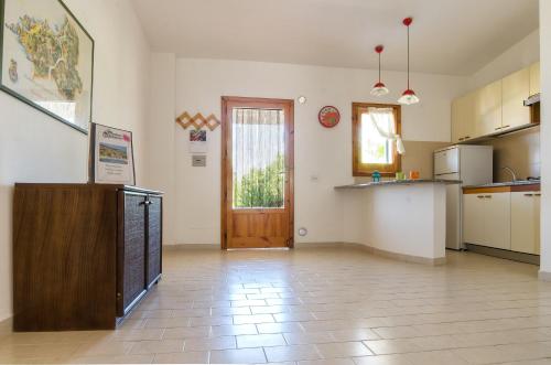 a large room with a kitchen and a door at Residence Albatros in Briatico