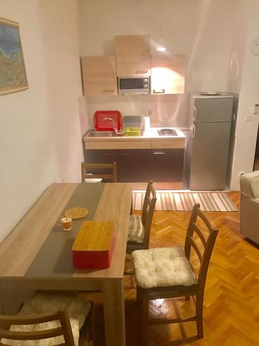 a kitchen and dining room with a table and a refrigerator at Lux dodo in Dramalj