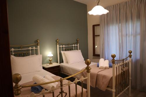a bedroom with two beds and a window at Villa Magia in Ýpsos