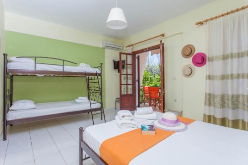 a room with two bunk beds and a balcony at Ionio Sea Poros Studios in Mikros Gialos