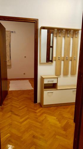 a bathroom with a mirror and a wooden floor at Lux dodo in Dramalj