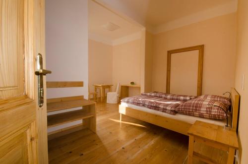 1 dormitorio con 1 cama y suelo de madera en Papperl a' Pub, en Schonberg am Kamp