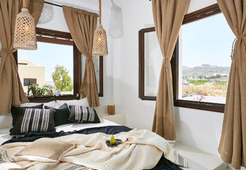 a bedroom with a bed and a large window at Le Blanc Suite in Mesaria