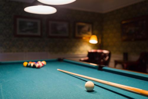 a billiard room with a pool table and balls at Fågelbro Säteri in Värmdö