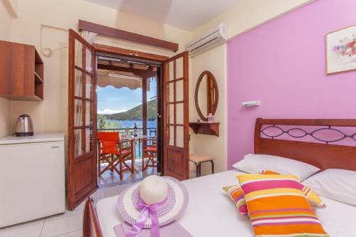 a bedroom with a bed with a view of the ocean at Ionio Sea Poros Studios in Mikros Gialos