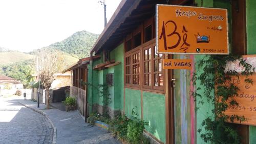 a building with a sign on the side of a street at Be Hospedagem in Lumiar
