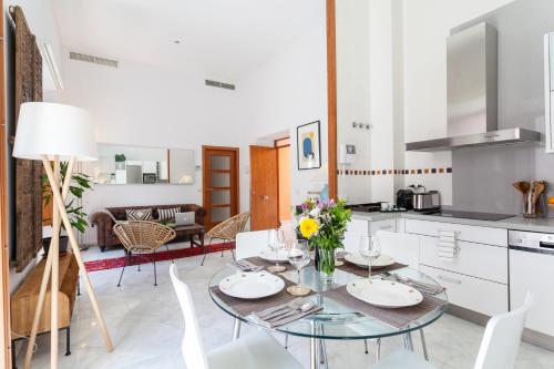 a kitchen and dining room with a table and chairs at Luxury Rooftop - Space Maison Apartments in Seville