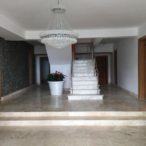 a large room with a chandelier and a staircase at Vista Marina Residence in Boca Chica