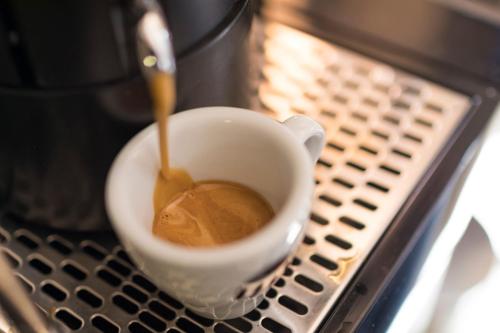 a cup of coffee sitting on a table at Beatus Suites And Rooms B&B in Canicattì