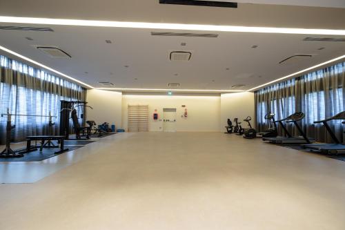 a gym with treadmills and elliptical machines at Hotel Mirasole International in Gaeta