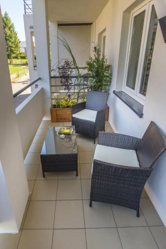 a balcony with two chairs and a table at Dom Wypoczynkowy Oskar Jastrzębia Góra in Jastrzębia Góra