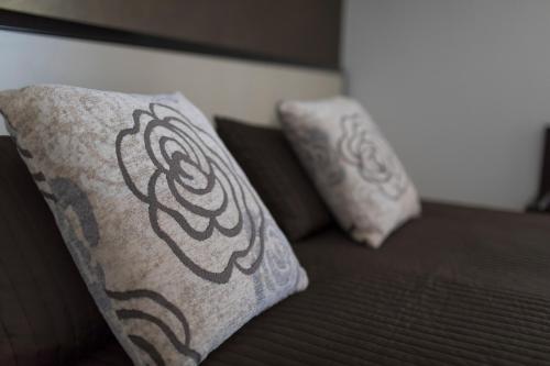 two pillows on top of a bed with at Beatus Suites And Rooms B&B in Canicattì