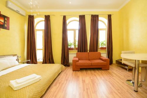 a bedroom with a bed and a chair and a table at Partner Guest House Baseina in Kyiv