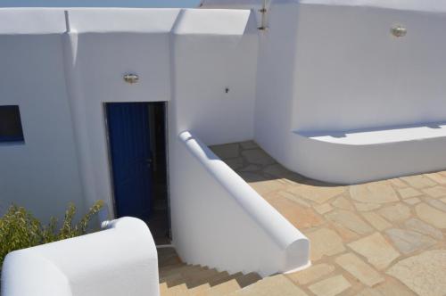a white bathroom with a sink and a toilet at Superb view House-Sikinos Island-Chorio in Síkinos