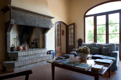 a living room with a couch and a fireplace at Parco Ducale Country House in Urbania