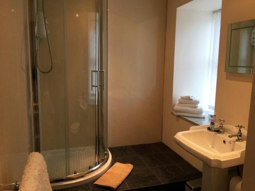 a bathroom with a shower and a sink at Belgrave Arms Hotel in Helmsdale