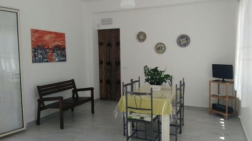 アルカモにあるFiori d'Ulivo Casa Vacanzaのダイニングルーム(テーブル、椅子、テレビ付)