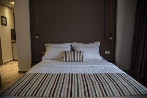 a large bed with two pillows in a bedroom at B. U. Luxury Apartments in Asprovalta