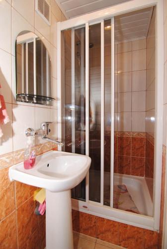 a bathroom with a sink and a shower at Guesthouse "Nakvynė pas žveją" Vetrungiu Street 298-2 in Nida