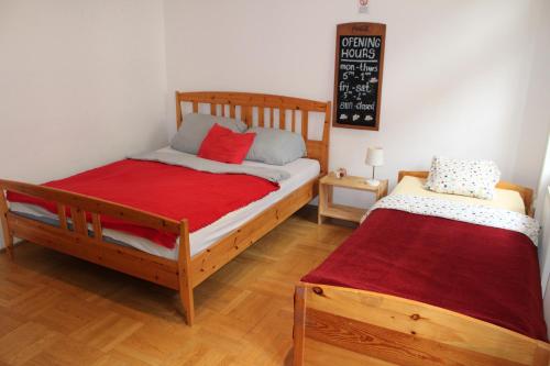 a bedroom with two beds and a chalkboard on the wall at Kiona Apartment in Budapest