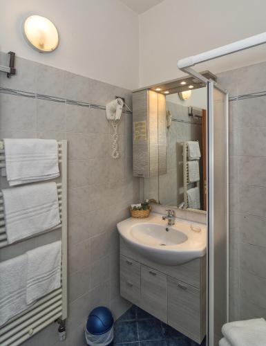 a bathroom with a sink and a mirror at Hotel Siesta in Lido di Camaiore