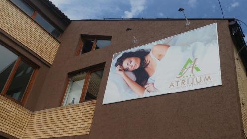 a sign on the side of a building at Atrijum Apartments and Rooms in Kladovo