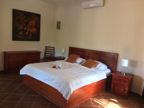 una camera con un letto e due tavoli e un quadro di La Villa Mexicana by Diving Prestige a Xpu Ha