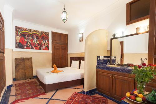 a room with a bed and a sink in it at Riad Zanzibar in Marrakech