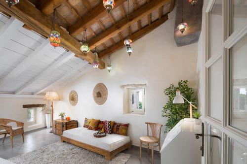 Casa Pharus في بال: غرفة معيشة بجدران بيضاء وسقوف خشبية