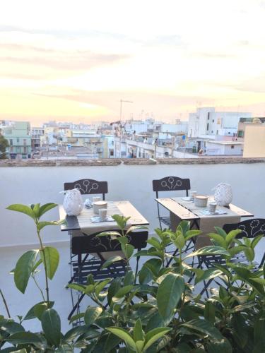two tables and chairs with a view of the water at Sibilla in Gallipoli