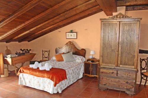 a bedroom with a bed and a dresser and a desk at Casa La Herradura in Royuela
