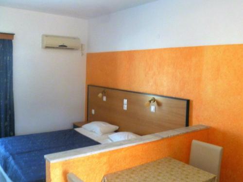 a hotel room with a bed with a blue mattress at Paraschos Studios Kos in Kardamaina