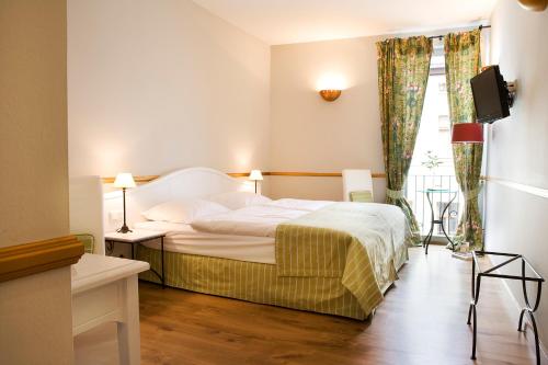 מיטה או מיטות בחדר ב-Pension La Casa dei Colori