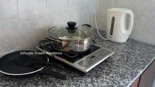 a pot on top of a stove in a kitchen at AFamosa Purple Dream Residence Condotel homestay in Melaka