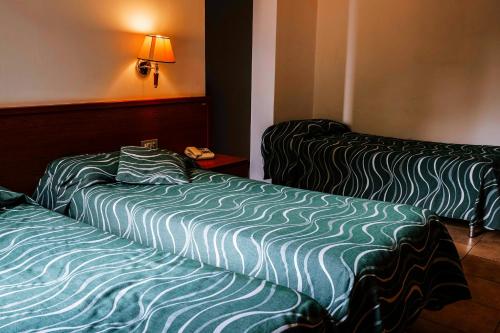 two beds sitting next to each other in a room at Agriturismo Cascina del Vai in Cairo Montenotte