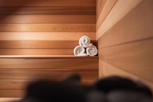 a room with wooden walls and a shelf with towels at 21c Museum Hotel Durham in Durham
