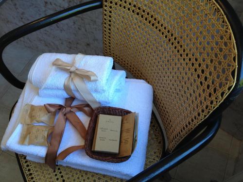 a chair with towels and a book and bows at Hotel Pedretti in Branzi