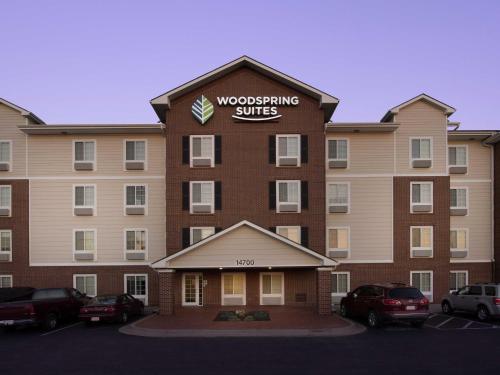 a building with a sign on the front of it at WoodSpring Suites Kansas City Lenexa in Lenexa