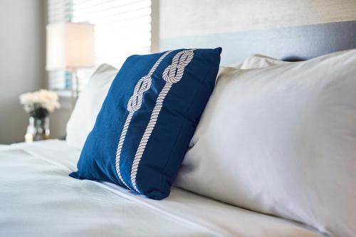 a bed with pillows and pillows on it at Shem Creek Inn in Charleston