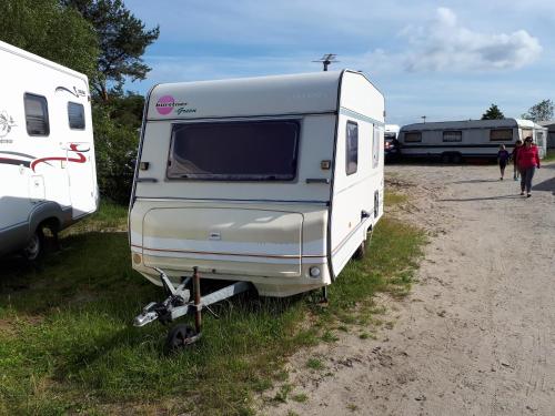 a camper parked in the grass next to two rvs at Przyczepy Kemping Polaris Półwysep Helski in Chałupy