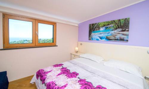 a bedroom with a bed and two windows at Casa Vacanze Li Galli in Sant'Agnello