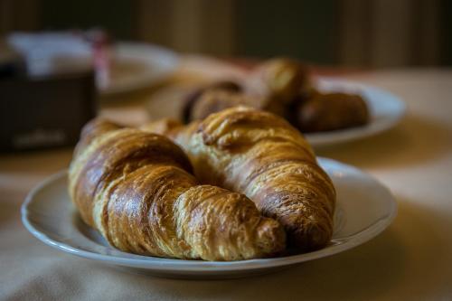 two plates of croissants on a table at Hotel Posta R.T.A. in Madonna di Campiglio