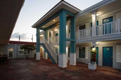 a large house with a staircase and a balcony at Southern Oaks Inn - Saint Augustine in Saint Augustine