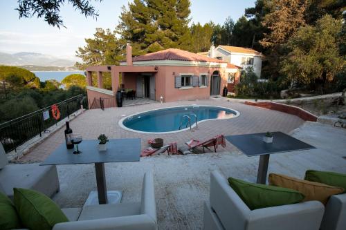 a villa with a swimming pool and a house at Lepeda's Pearl in Lixouri