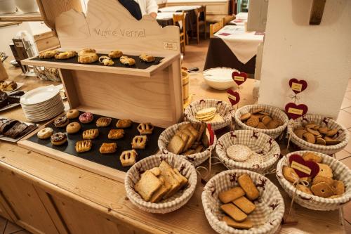 a table topped with baskets of cookies and pastries at B&B Col Da La Vila in Canazei