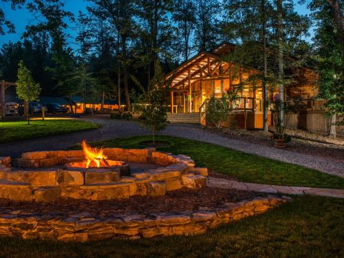 a fire pit in front of a house at Adventures on the Gorge in Fayetteville