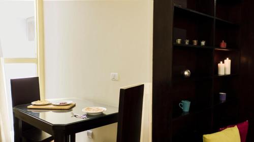 a small table in a room with a shelf at NewCity Hotel & Suites in Cairo